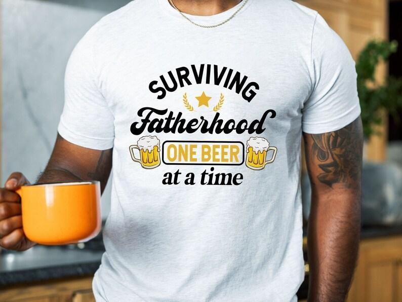 Surviving Fatherhood One Beer Time Shirt Funny Father Shirt Husband Shirt Fatherhood Shirt Beer Dad Shirt T-Shirts